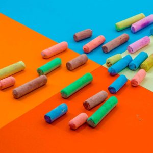 Colored crayons on a paper background