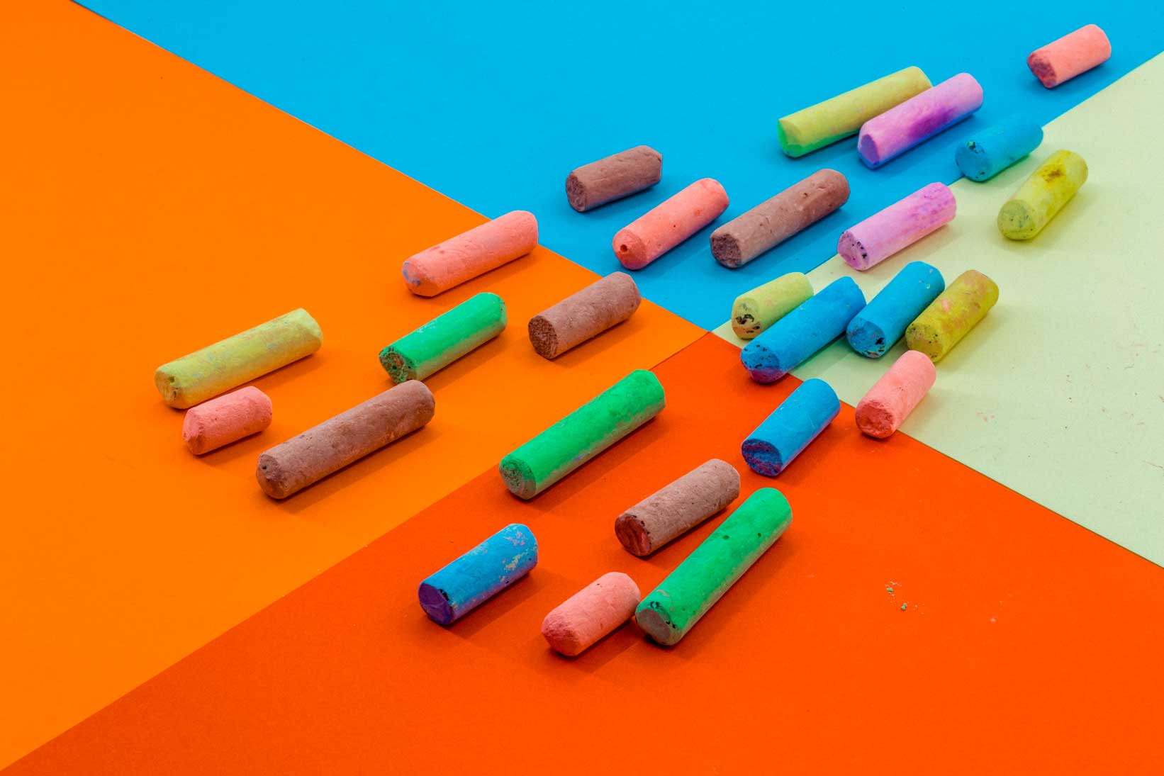 Colored crayons on a paper background